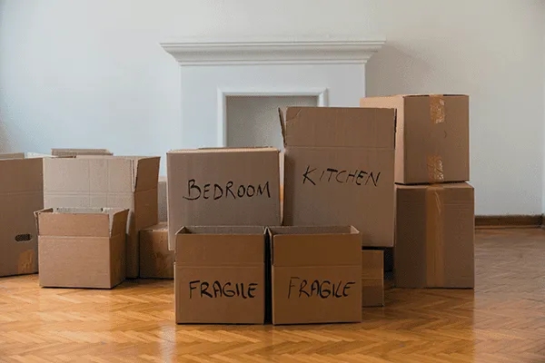 Several cardboard moving boxes labeled 